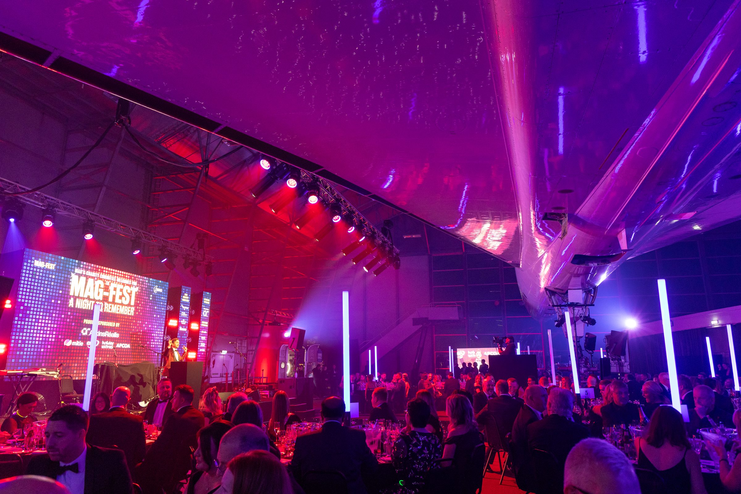 The MAG Charity Ball room, tables full under the stage lighting